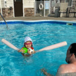 little girl in swimming pool at the beach house at lake street in holland michigan